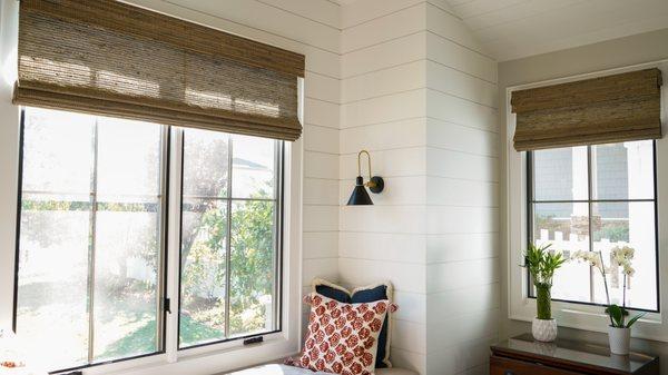 Motorized woven wood shades.