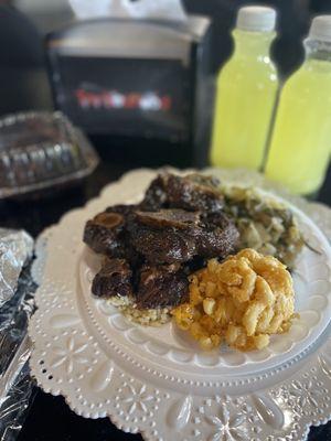 Ox tails and rice Mac and cheese and cabbage, their Tru Lemonade and Chocolate Cake