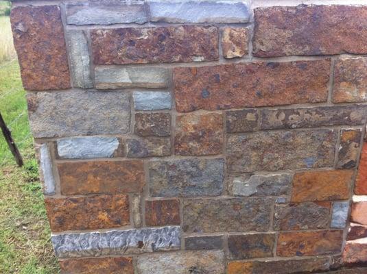 Rust with blue stone wall, gray mortar