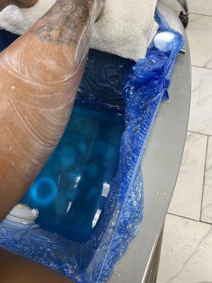 The tub showing the sanitary bags for pedi service