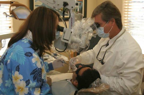 Dr. Daws and an assistant working with the two operator surgical microscope