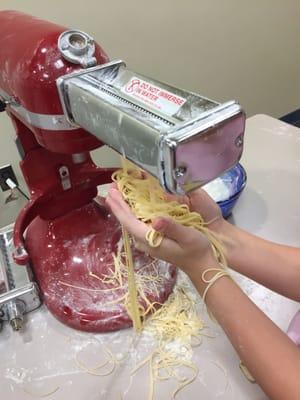 Cutting pasta sheets into spaghetti!