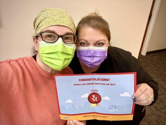 Our hygienist Tiffany and Treatment Coordinator Angela G showing off our 2020 Yelp award!