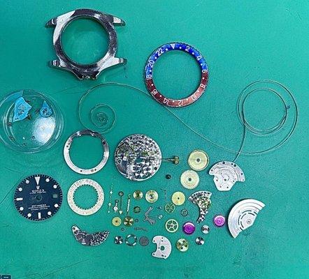 Rolex GMT fully disassembled by our watchmaker for factory style cleaning and overhaul service.