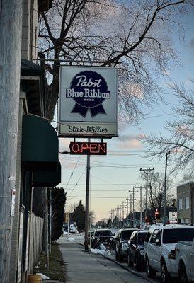 Slick Willie's sign with a sweet sunset & some Midwestern March snow on the ground.