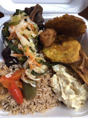 Fried pork (Griot) rice and beans, potatoes salad, akra, fried plantain, and fried white sweet potato