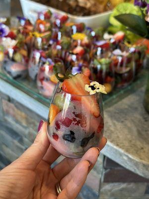 Mini fruit cups between main meal and dessert.