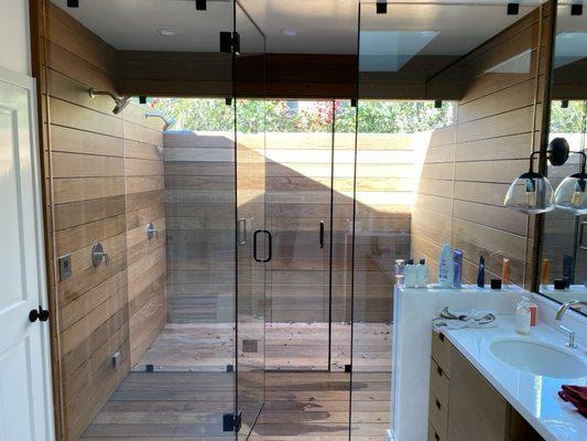 Exotic IPE wood clads this lovely indoor/outdoor shower.