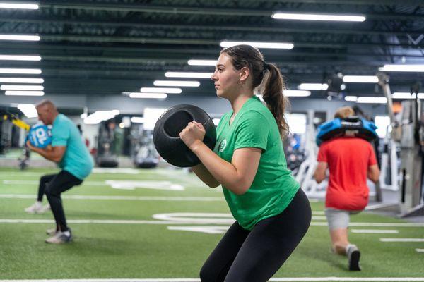 Our Functional Training Space has a sled, boxing bag, TRX, kettlebells, weights, weighted balls, bags, and more.