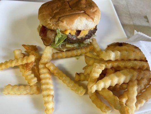 Bacon cheeseburger with fries.