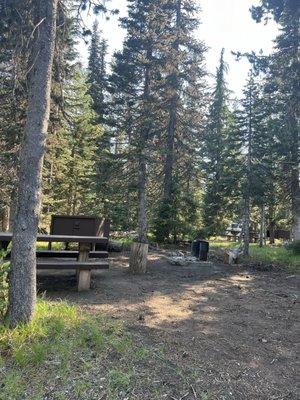 The campsites are not paved, and the dirt is dusty and loose.  Many trees, but the temperature is pretty high in this area in summer.