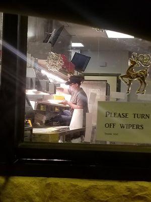 Girls sitting on counter during service hours. 8:45pm on a Sunday night. 
 One with feet on the counter "cleaning" the food transfer window.