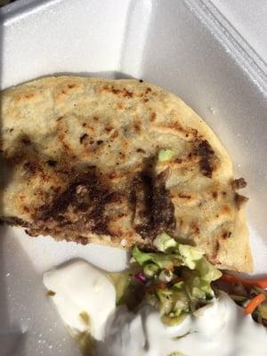 Asada & Cheese Pupusa w/ a side of mild salsa, salad topping, and crema