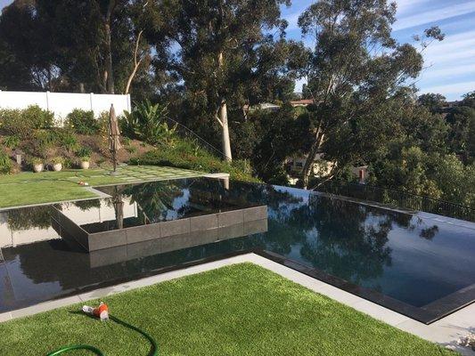 Mission Viejo pool and spa remodel with all new black pebble surface.