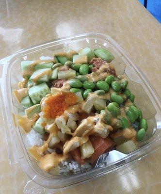 Regular poke bowl: white rice, spicy tuna, salmon, masago, edamame, cucumbers, corn, pineapple, spicy mayo