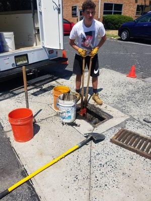 removing debris from parking lot culverts