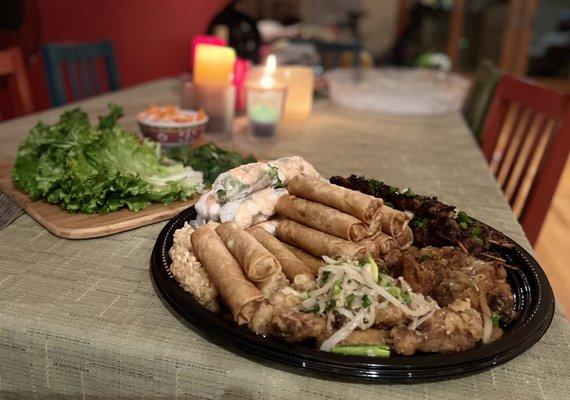 Party Tray with spring rolls, egg rolls, calamari, chicken wings (2 types - house and garlic butter), pork skewers