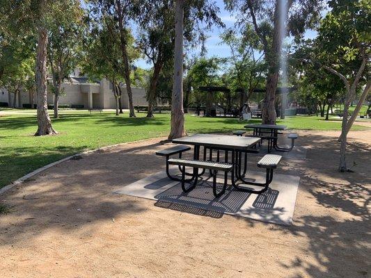 Picnic table at the Park w the shelter in the background 06.2022