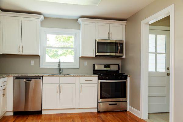 Classic white cabinets with granite counter tops, tough to go wrong with this timeless combo!