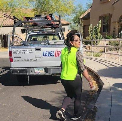 License plate & company details on truck and his significant other in the vest