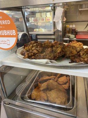 Some of their hot foods--Zucchini fritters on top and chicken cutlets