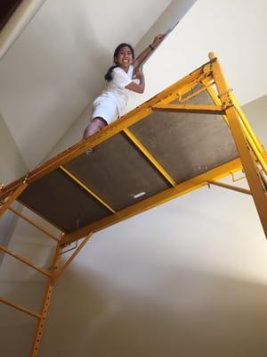 Alexis. Using scaffolding to repair Sheetrock before painting