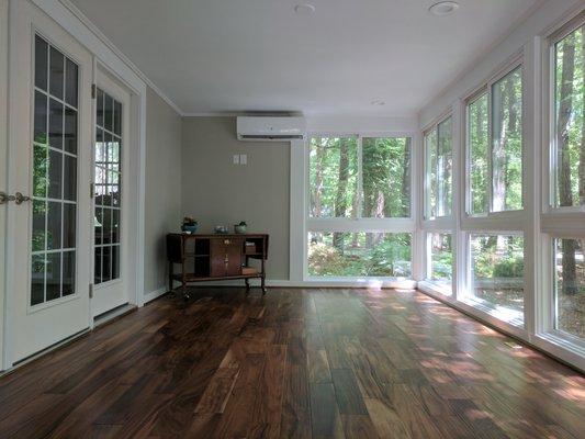 Former porch to living space with all glass walls and new composite deck