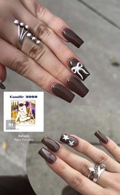 Brown acrylics with white bow and white stars