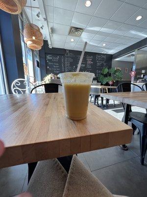 Mango and soy milk on a table looking at the menu of dumplings