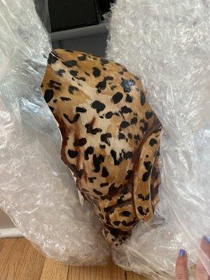 Damaged ceramic leopard statue, completely cracked in half.