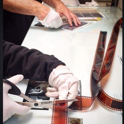 Film technicians cutting film at Photolab film department