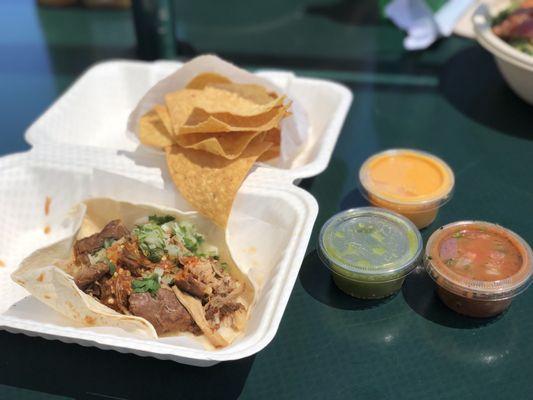 One carnitas Taco $5-6, $1 queso, chips complimentary salsa