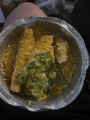 Cold cheese with guacamole vomit on top of "rolled tacos"