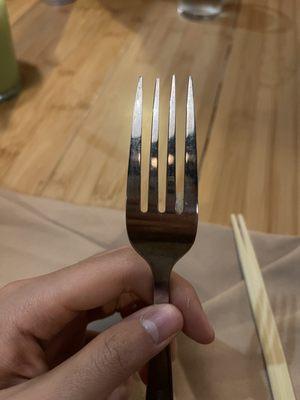 A tried rice on an unused fork