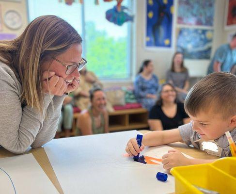 Head of School Jenn Lindsay is entranced by a young artist's creativity.