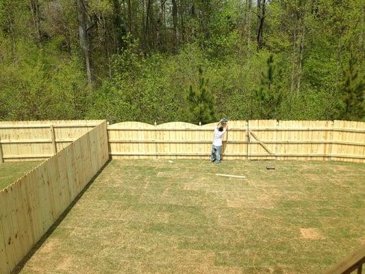 Our fence on the right being put in with the scallops being cut. Job was completed beautifully in one day.