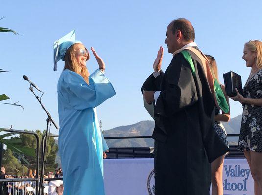 Jessy Shelton high fives Greg Krikorian from the Glendale Unified School District at the 2017 Crescenta Valley High School commencement.