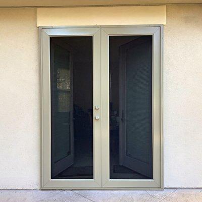 Professional security screen door installation for French set front doors in Austin. Viewguard style pictured.