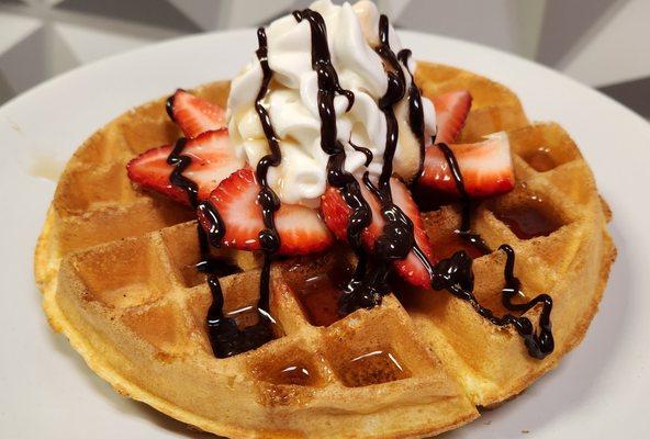 Belgian waffle with fresh strawberries, whipped cream, chocolate sauce & syrup.