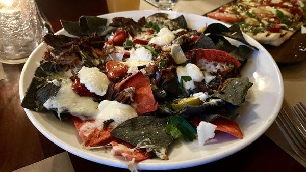 'Italian nachos'. Braised beef ragu, mozzarella, ricotta, and cherry peppers topped these nachos. Delicious!