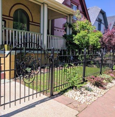 Custom Wrought Iron Fencing with Medallion on Gate.