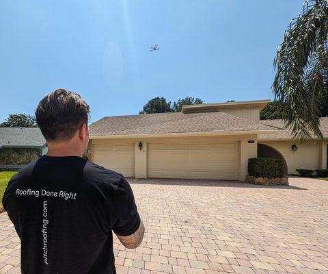 Owen inspecting a roof with the drone