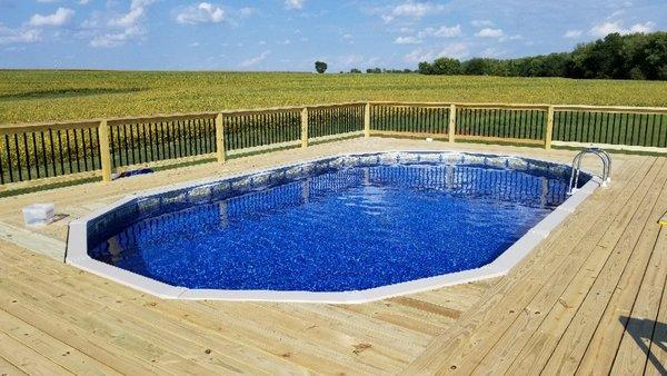 Deck and handrail added to an above ground pool.