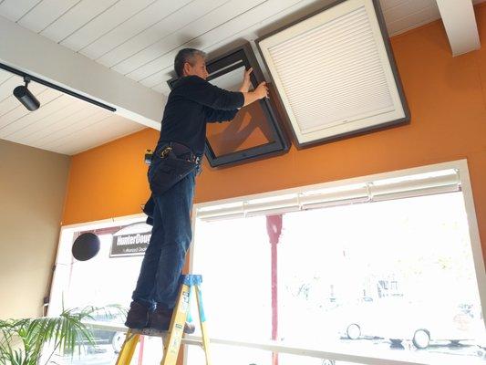 Ward (owner) installing some of the last displays in our new showroom!