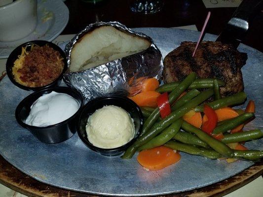 Bacon wrapped Filet Mignon with a side of veggies and a baked potatoe with everything.