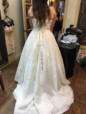 She did an amazing job by completely re-designing the back of my dress and adding a corset