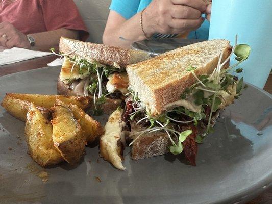 Veggie Hummus sandwich with potato wedges.