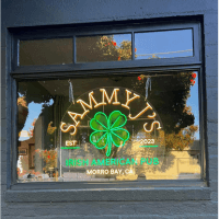 Neon sign inside business side window.