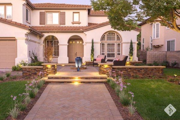 Front yard curb appeal remodel completed with paver patio, entryway and wall, water feature, new landscape design and ambient lighting