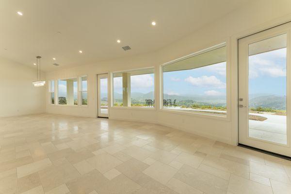 Vaulted ceilings, tile flooring, and large picture windows in a custom home designed and built in Fallbrook, CA